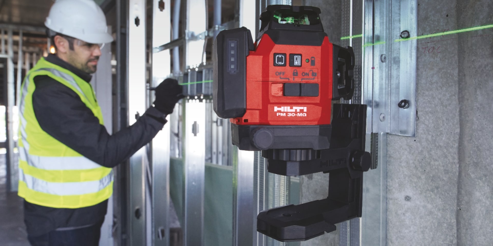 A worker operates a Hilti measuring tool